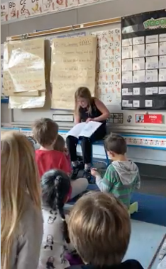 Willamette fourth-grader DJ Perkins reads her story to Willamette students.  